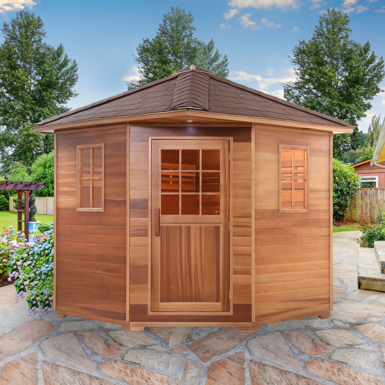 Canadian Red Cedar Wet Dry Outdoor Sauna with Asphalt Roof - 8 kW UL Certified Heater - 8 Person - Square On View in a Garden Setting